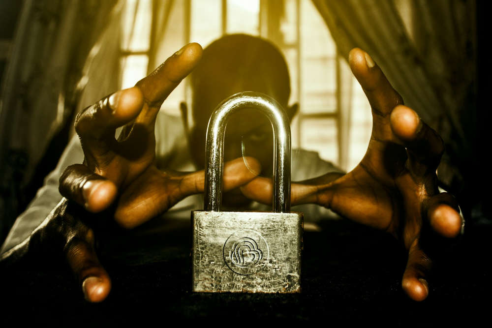 Man trying to open a padlock with his mind